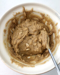 Ingredients for SCD Peanut Butter Cookies in a mixing bowl all mixed up