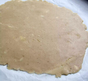 Grainfree Almond Flour Pastry between sheets of greaseproof paper