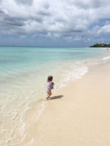 Little girl paddling at Paradise Beach in Barbados
