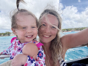 Mother and daughter windswept on a boat in Barbados