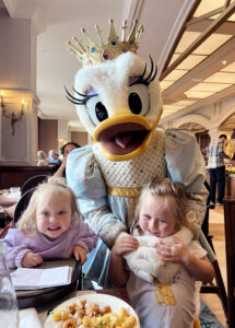 Girls meeting Daisy at the Royal Banquet at disneyland Paris