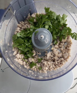 Blending smoked mackerel with lemon juice and parsley